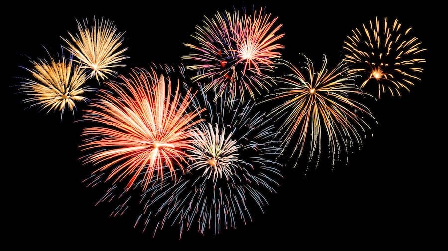 Spectacular Independence Day fireworks display over pine trees in Arizona White Mountains